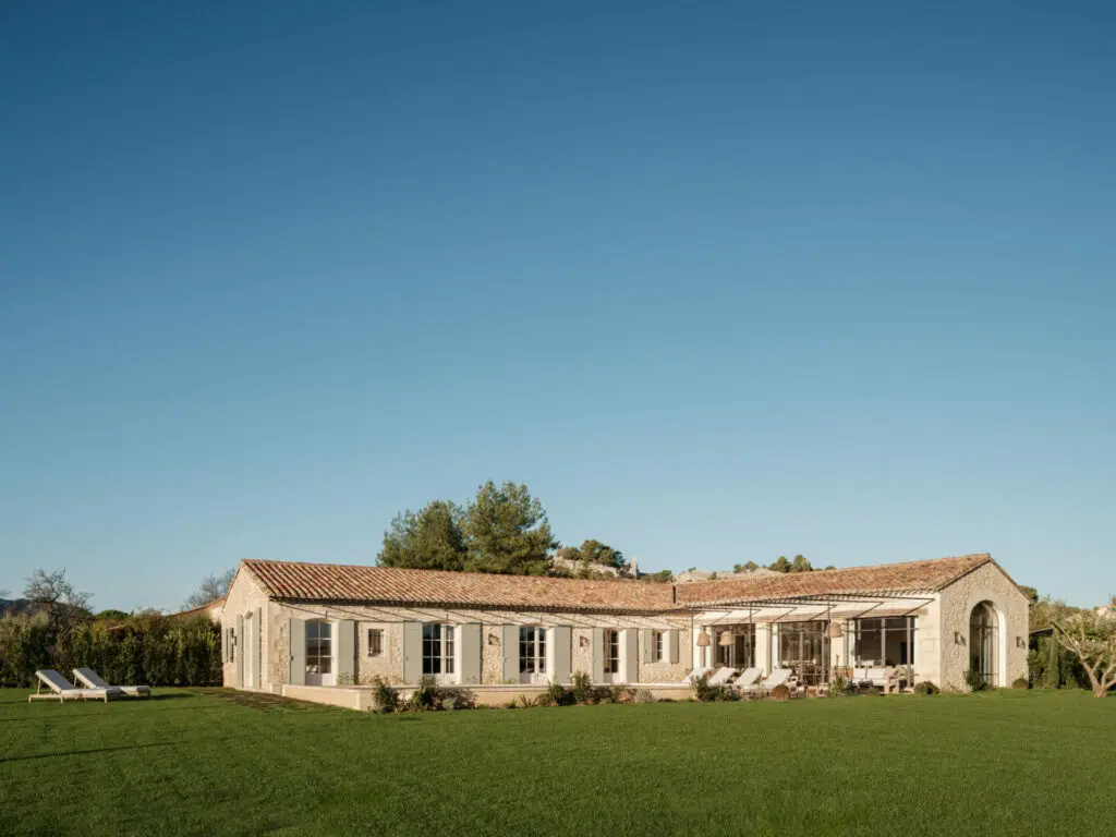 Longue façade du mas, volets bois et toiture en tuiles rondes